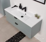 Szafka łazienkowa w miętowym kolorze wraz z białą dolomitową umywalką z serii Magnolia