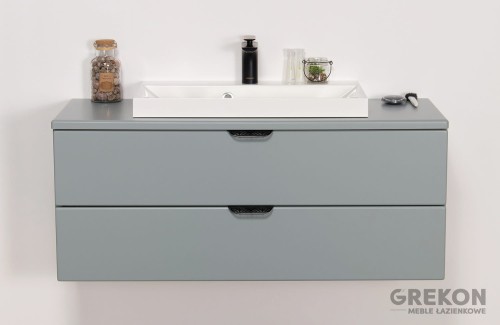 Elegancka szafka łazienkowa w miętowym kolorze z białą umywalką