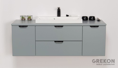 Szafka do łazienki w matowym miętowym kolorze z białą umywalką