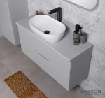 Szara matowa szafka z blatem oraz białą umywalką