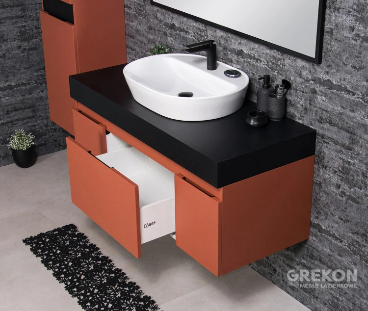 Nowoczesna elegancka szafka łazienkowa w kolorze ceglastym z blatem oraz białą ceramiczną umywalką